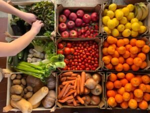 Organic fruit and veg box delivery with crates of seasonal vegetables and fruit